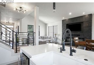 kitchen featuring a notable chandelier, sink, a wealth of natural light, and vaulted ceiling