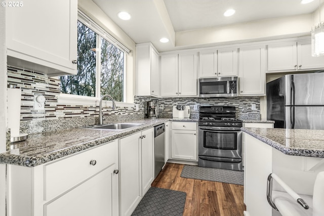 kitchen with white cabinetry, sink, and stainless steel appliances