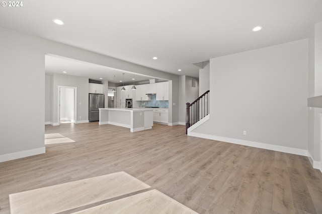 unfurnished living room featuring light hardwood / wood-style floors