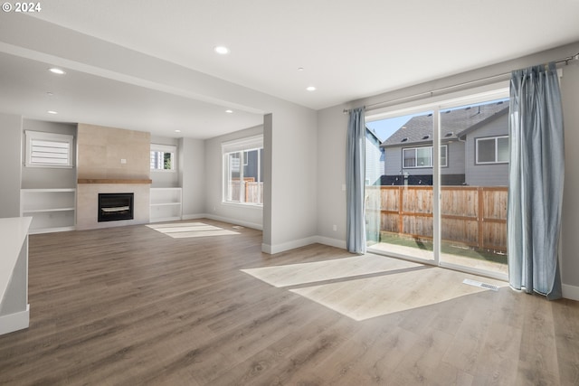 unfurnished living room featuring wood-type flooring and a fireplace