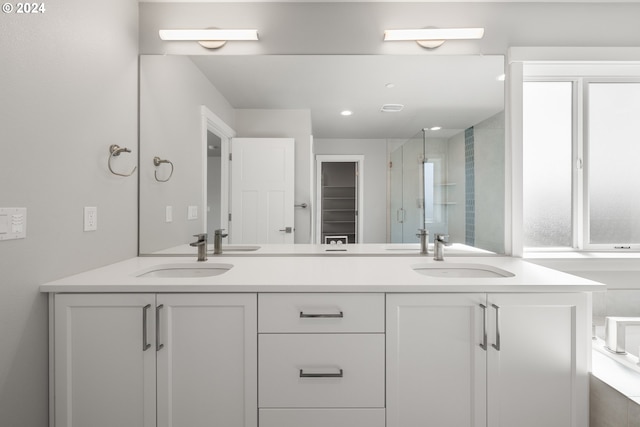 bathroom featuring vanity and a shower with shower door