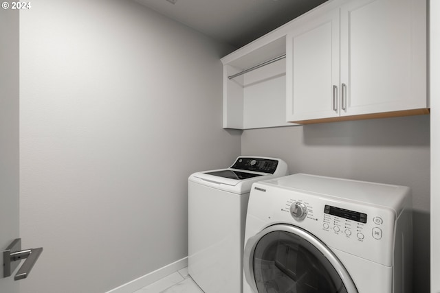 laundry room featuring cabinets and washing machine and clothes dryer