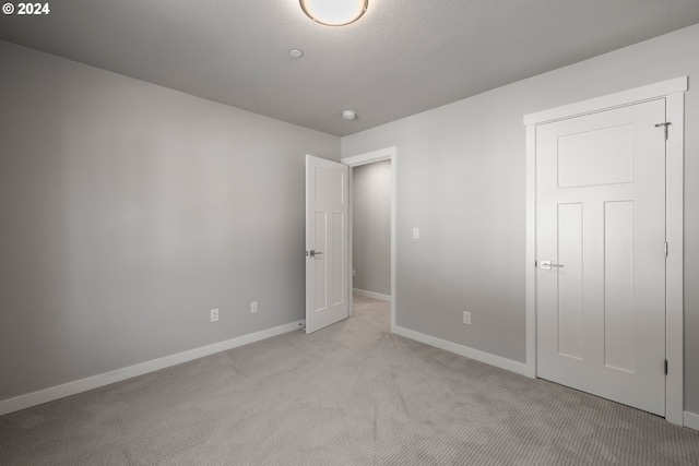 unfurnished bedroom with light carpet