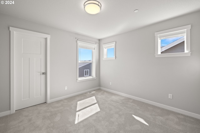 spare room with light colored carpet