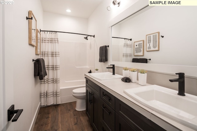 full bath with toilet, wood finished floors, a sink, and shower / tub combo with curtain