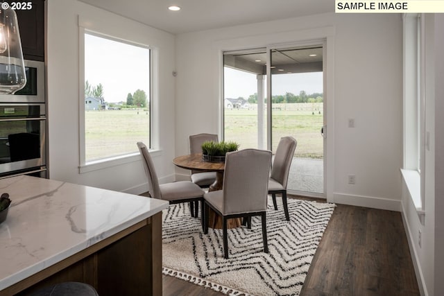 dining area with recessed lighting, dark wood-style flooring, and baseboards