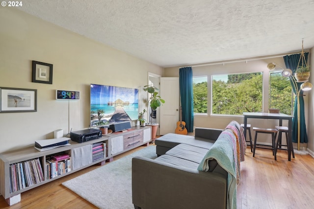 living room with light hardwood / wood-style flooring and a textured ceiling