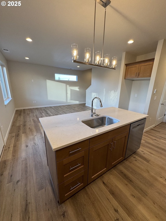 347 SE Shetterly Dr, Dallas, OR 97338 - kitchen featuring hanging light fixtures, dark hardwood / wood-style flooring, sink, stainless steel dishwasher, and light stone counters