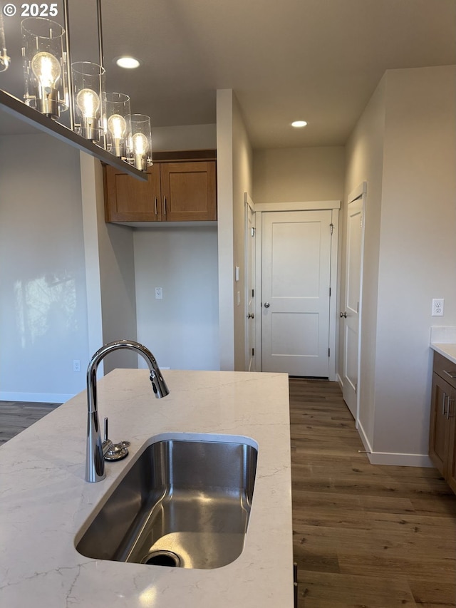 347 SE Shetterly Dr, Dallas, OR 97338 - kitchen featuring hanging light fixtures, sink, dark wood-type flooring, and light stone countertops