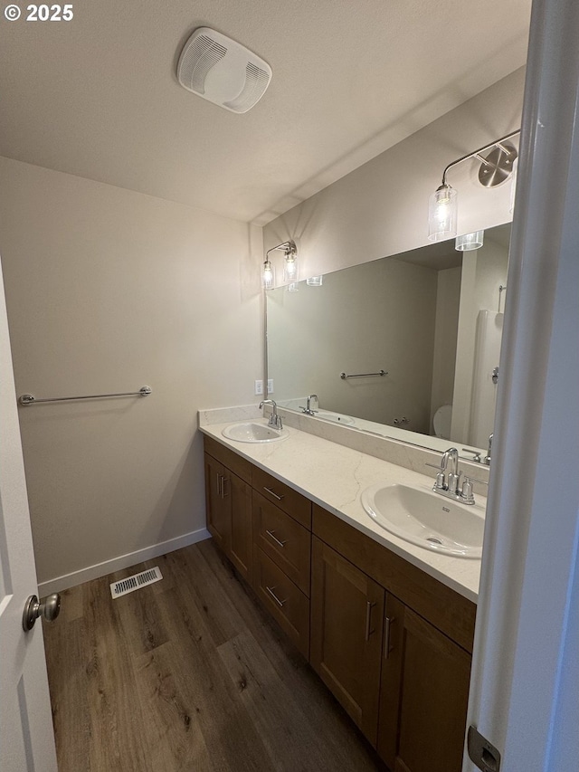 347 SE Shetterly Dr, Dallas, OR 97338 - bathroom featuring toilet, vanity, and hardwood / wood-style floors