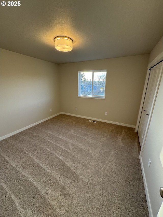347 SE Shetterly Dr, Dallas, OR 97338 - unfurnished bedroom featuring a textured ceiling, a closet, and carpet