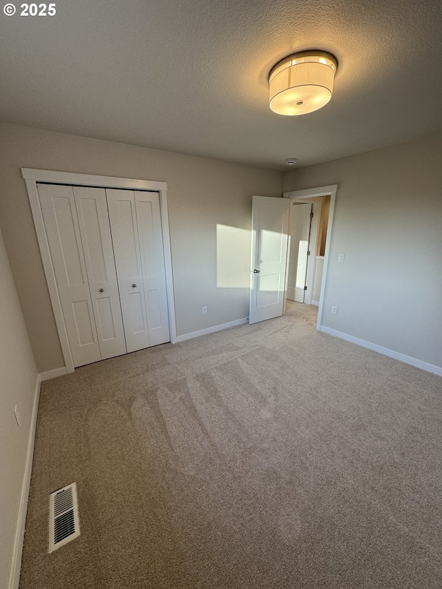 347 SE Shetterly Dr, Dallas, OR 97338 - unfurnished bedroom with a closet, carpet flooring, and a textured ceiling