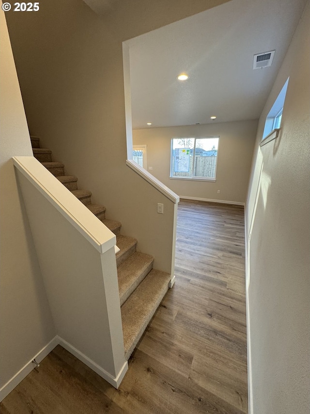 stairs with hardwood / wood-style floors