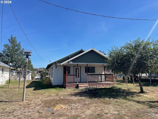 bungalow-style home with a front lawn and a porch