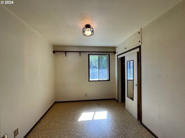 empty room with a textured ceiling