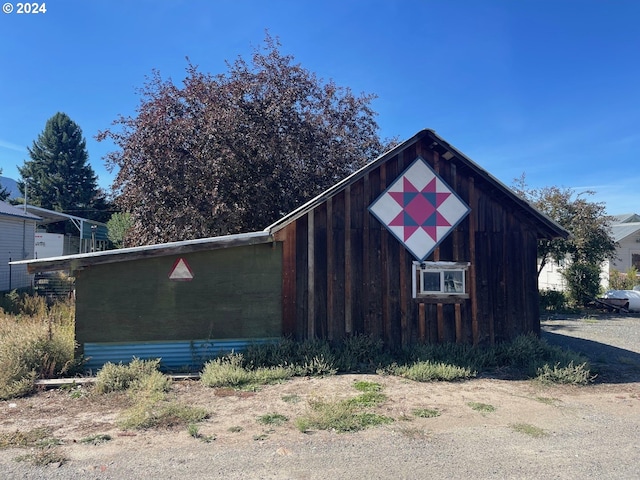 view of property exterior featuring an outbuilding