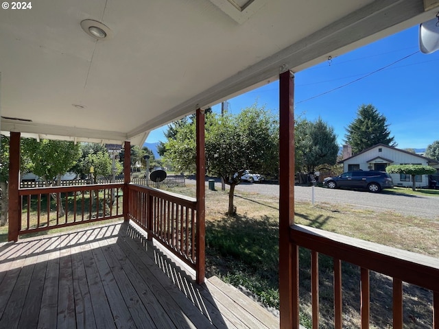 wooden deck featuring a lawn