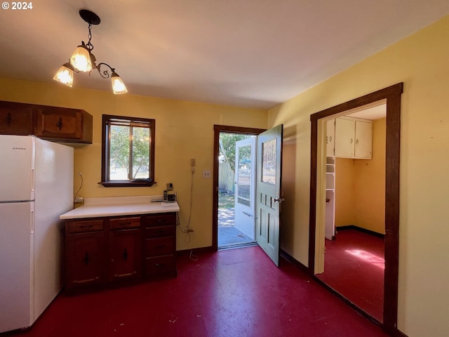 kitchen with white refrigerator and hanging light fixtures