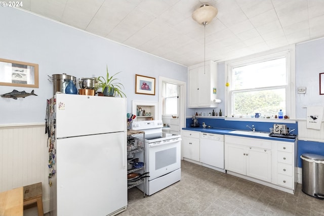 kitchen with white cabinets, white appliances, a wealth of natural light, and sink