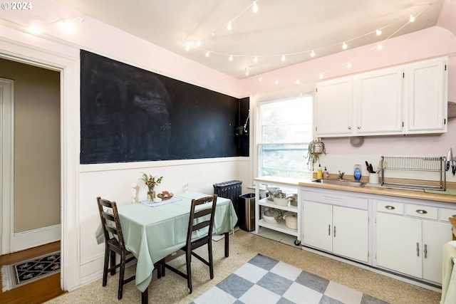 kitchen featuring sink and white cabinets