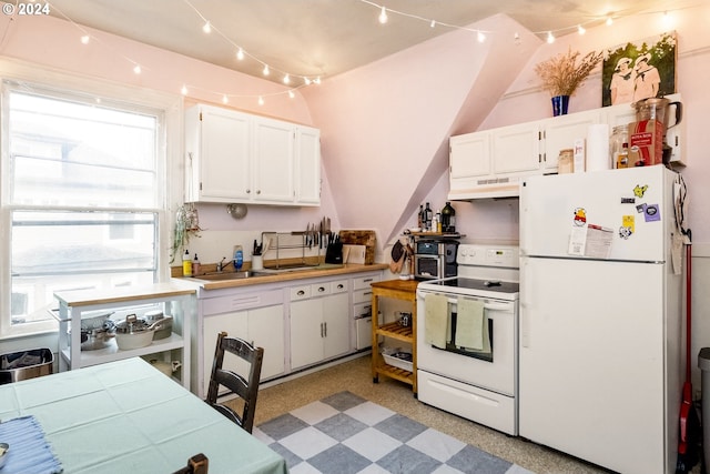 kitchen with white cabinets, lofted ceiling, white appliances, and sink