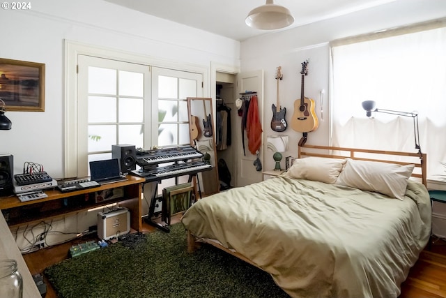 bedroom with wood-type flooring and a closet