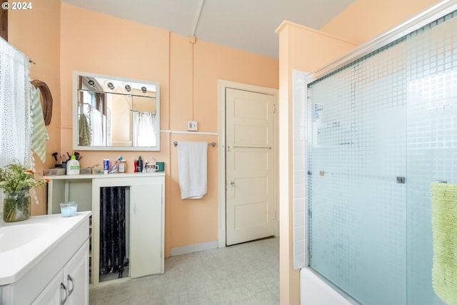 bathroom featuring shower / bath combination with glass door and vanity