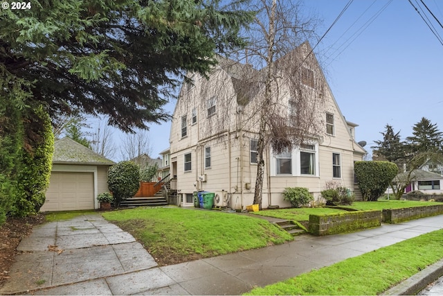 view of property exterior with a lawn and a garage