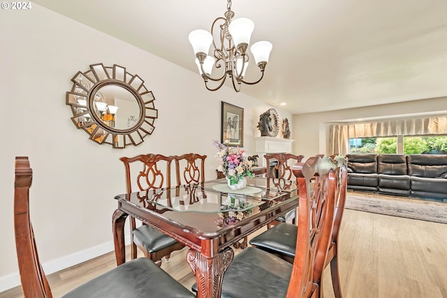 dining space featuring light hardwood / wood-style flooring and a chandelier