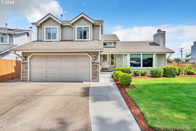 view of front of property featuring a garage and a front lawn