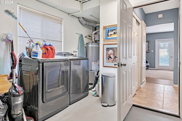 washroom with washer and clothes dryer and water heater