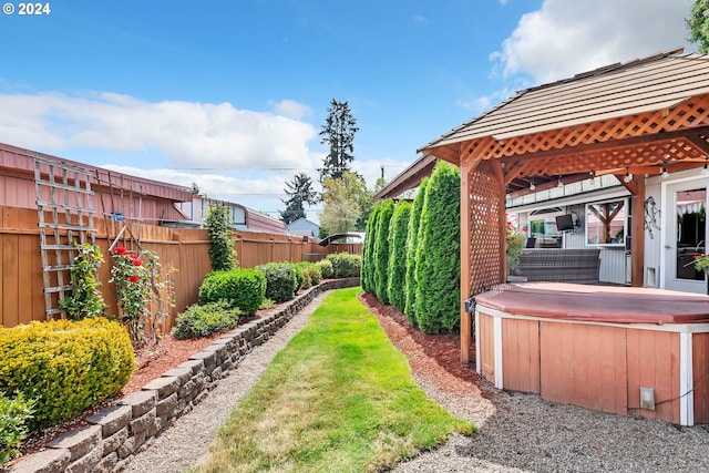 view of yard featuring a gazebo and a hot tub