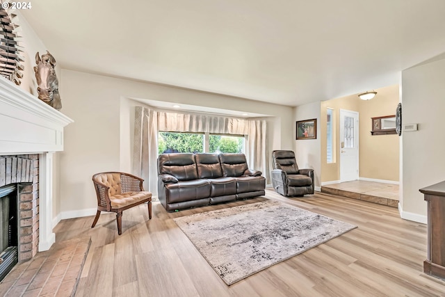 living room with a fireplace and light hardwood / wood-style flooring