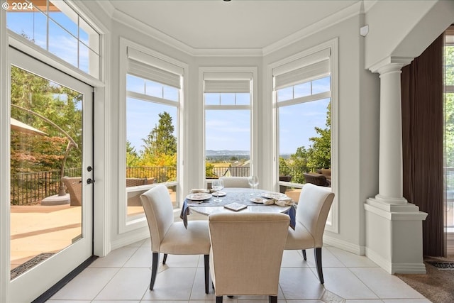 sunroom / solarium featuring a wealth of natural light and ornate columns