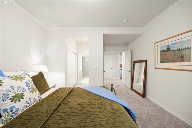 bedroom with ornamental molding and light carpet