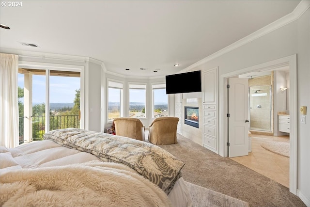 tiled bedroom with crown molding and access to exterior