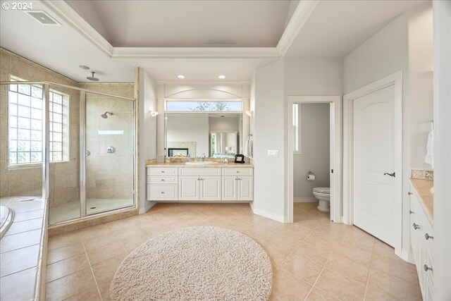 full bathroom featuring vanity, toilet, plus walk in shower, and tile patterned floors