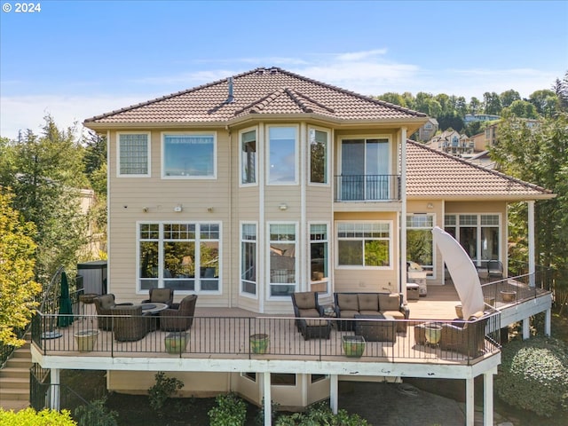 back of house with an outdoor living space and a wooden deck