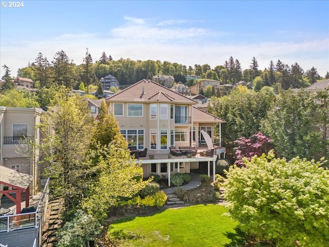 rear view of property featuring a lawn