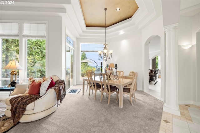 tiled dining room with a wealth of natural light, a chandelier, and ornate columns