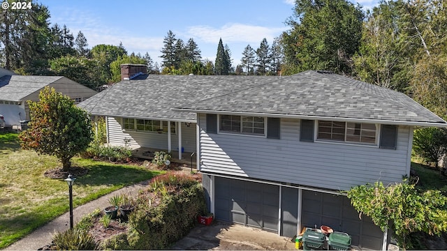 view of front of house with a front lawn and a garage