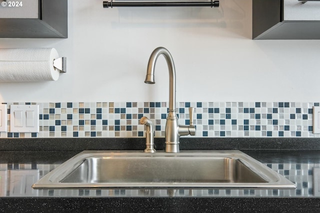 room details featuring sink and tasteful backsplash