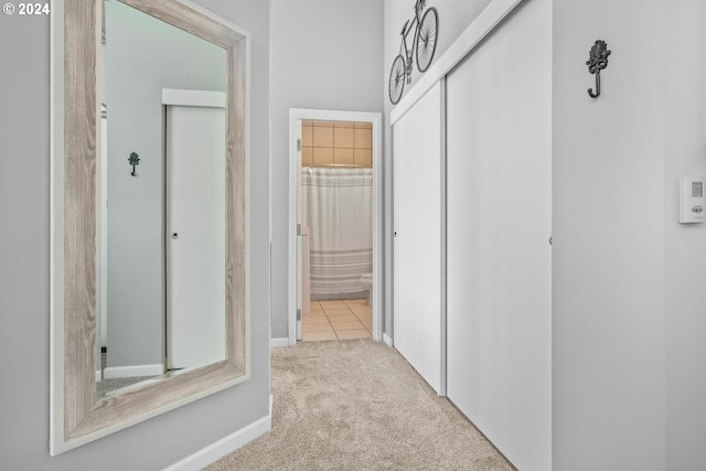 hallway with light colored carpet