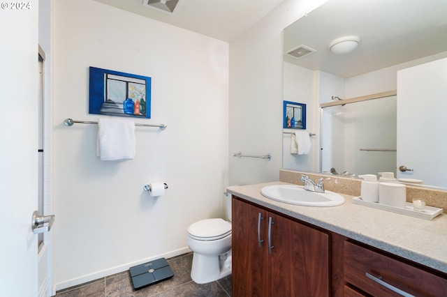 bathroom featuring tile patterned flooring, vanity, and toilet