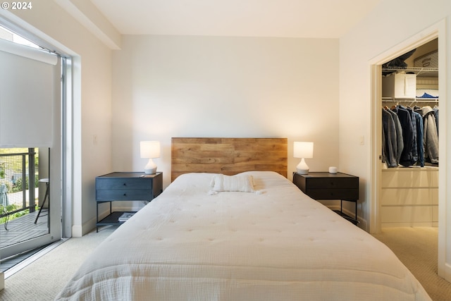 carpeted bedroom with access to outside, a walk in closet, and a closet