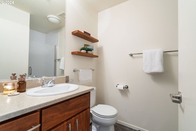 bathroom with tile patterned flooring, vanity, and toilet