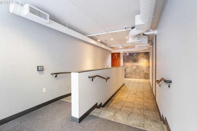 hallway with tile walls