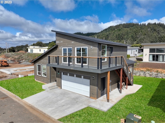 view of front of house with a front yard and a garage