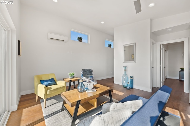 living room featuring dark wood-type flooring and a wall unit AC