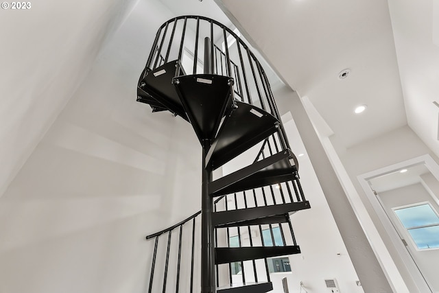 stairs featuring a high ceiling